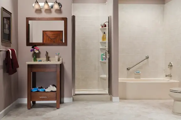 Biscuit tub and travertine tile shower in showroom