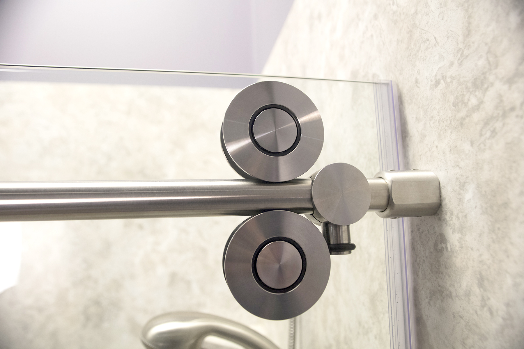 Brushed nickel barn-style sliding shower door hardware close-up