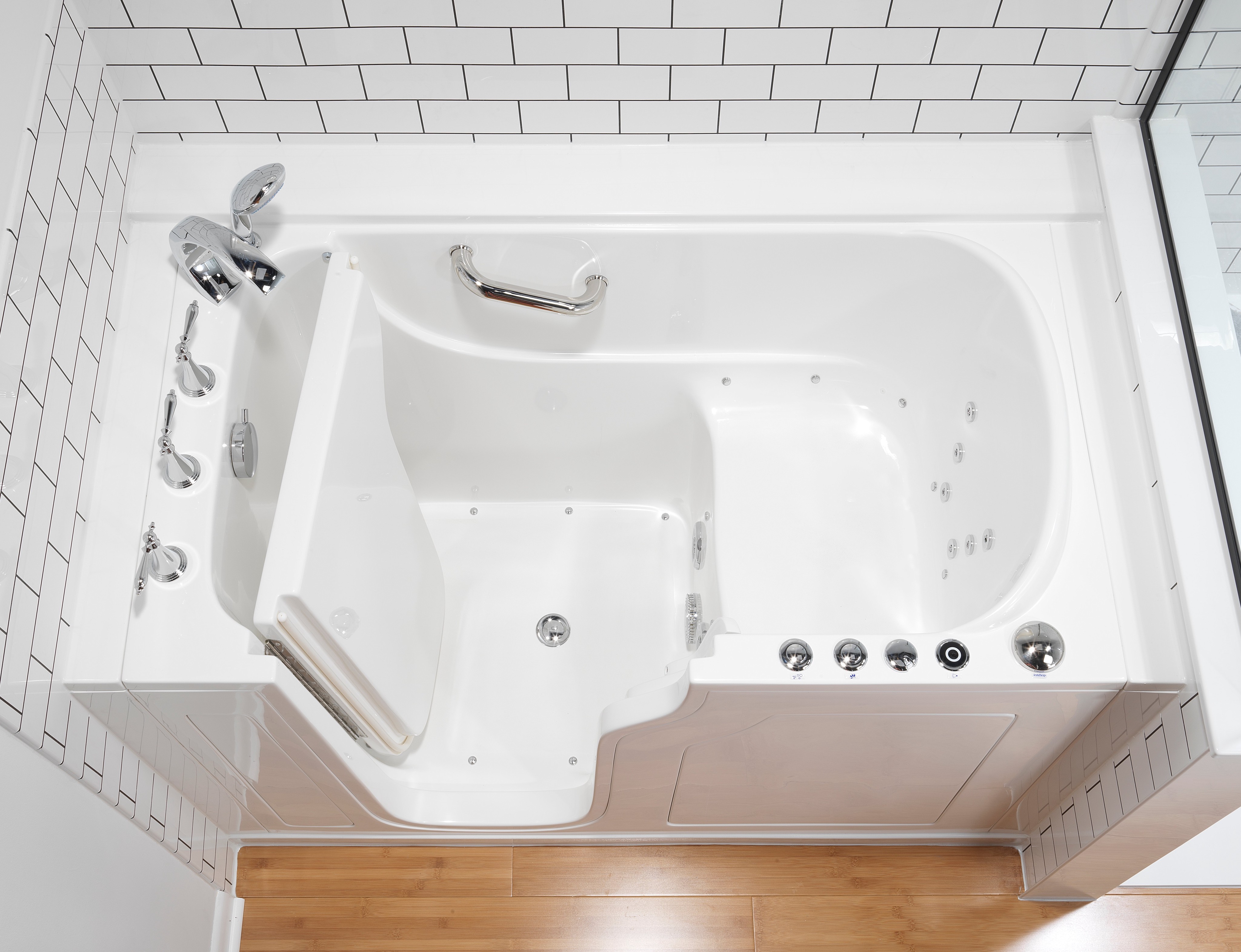 Overhead view of white walk-in tub with hydrotherapy jets and chrome fixtures
