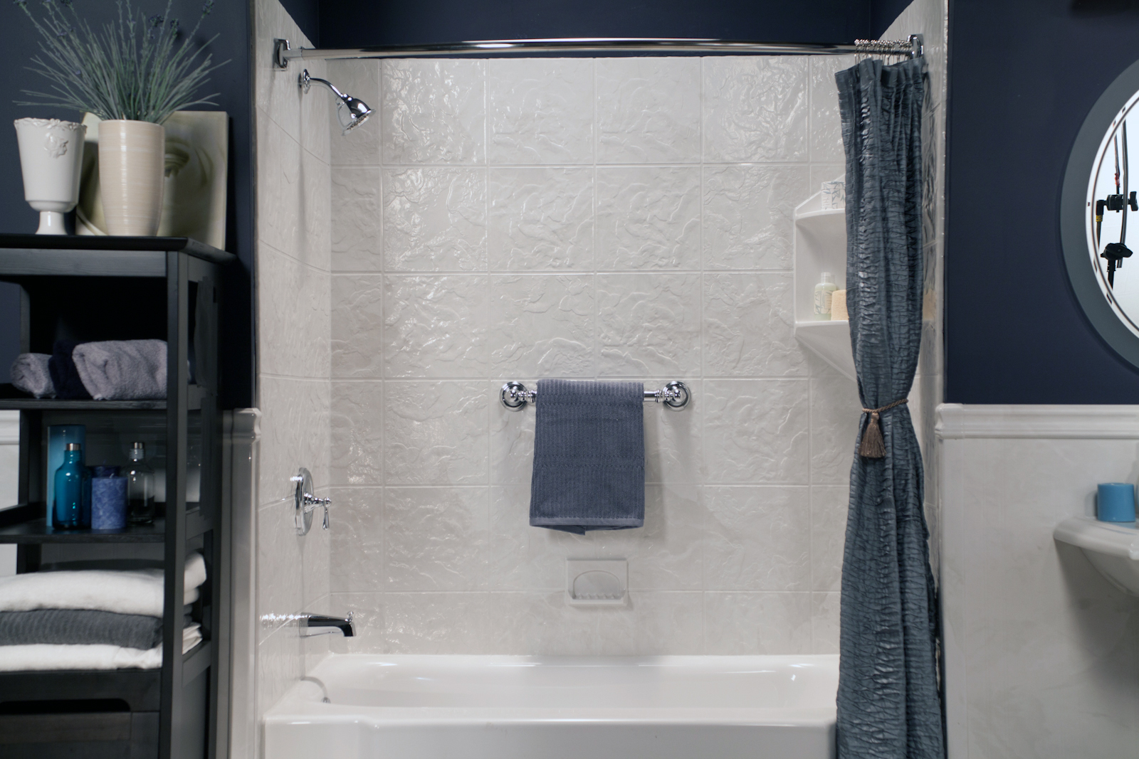 White classic tub and shower with silver white textured walls and polished chrome